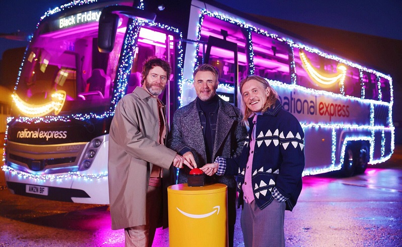 Take That members with a light up National Express coach